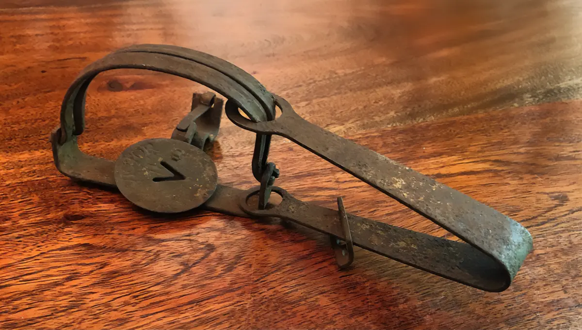 A vintage forged steel rat trap by Oneida Victor from the late 1800s or early 1900s.